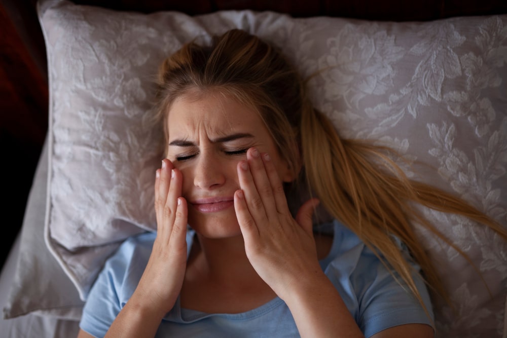 Woman with face pain due to Bruxism