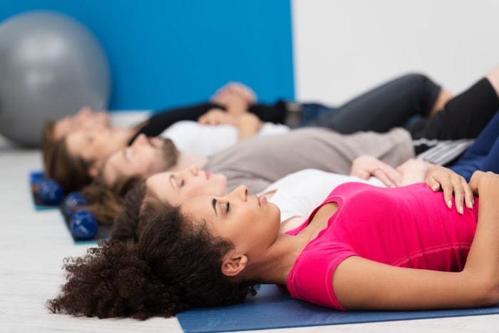 yoga group practicing yoga to manage migraine