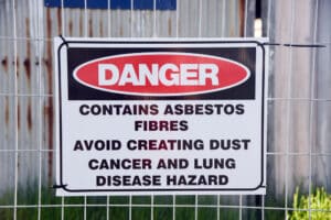 warning sign: Contains Asbestos Fibers Avoid Creating Dust. Cancer and Lung Hazard
