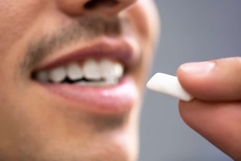 smiling man chewing gum